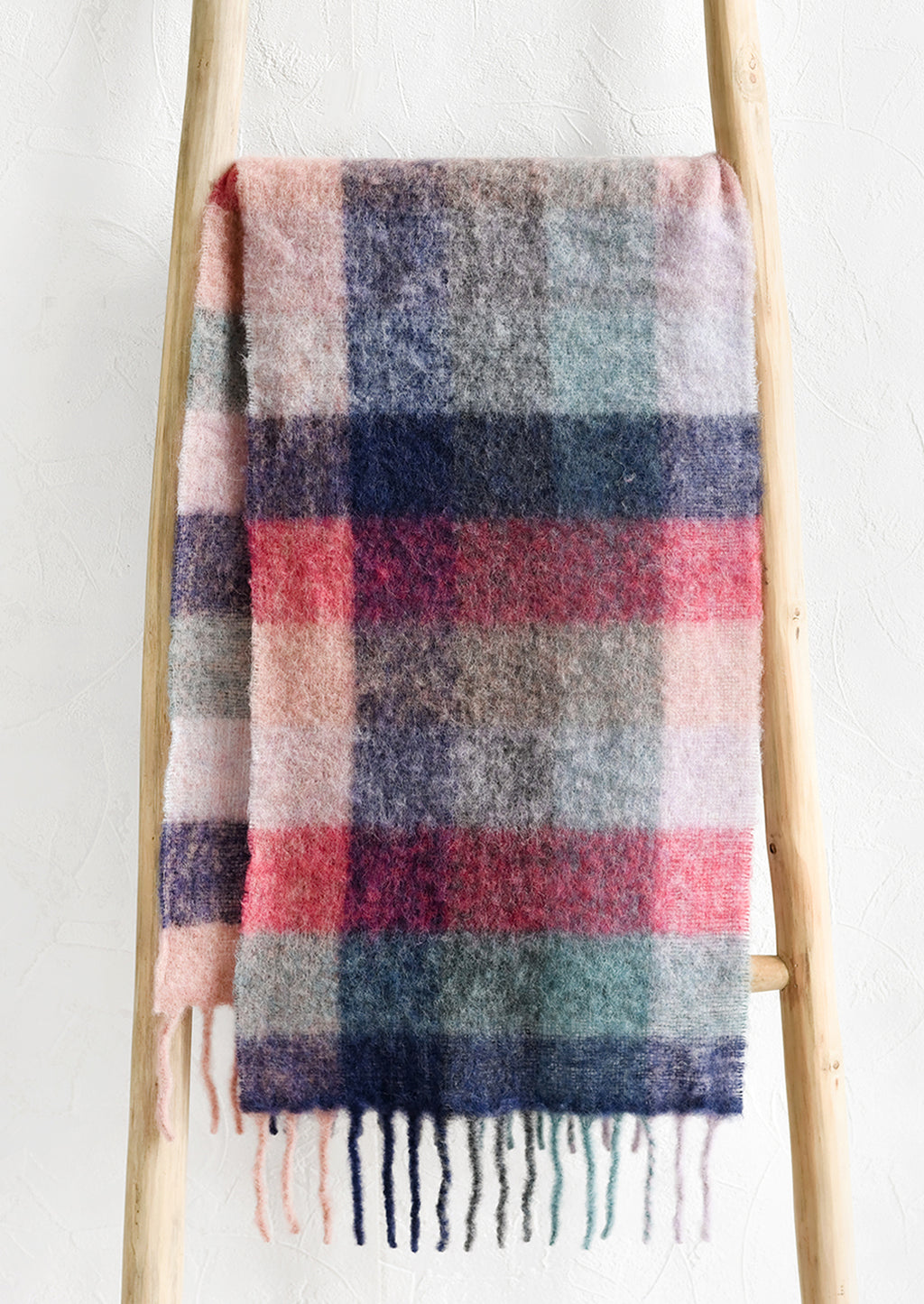 1: A fuzzy woven wool scarf in pastel madras pattern.