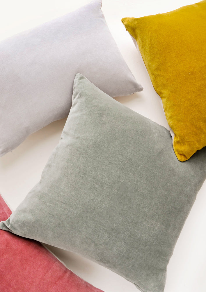 Colorful velvet throw pillows scattered together
