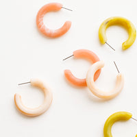 1: Scattered array of different colored hoop earrings in matte resin