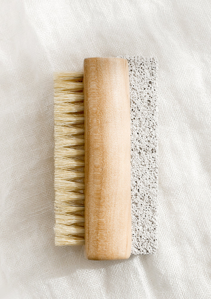 1: A light wood nail brush with brush on one side and pumice stone on the other.