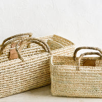 2: Palm leaf storage baskets with handles in slim, squared shape; three sizes that nest together.