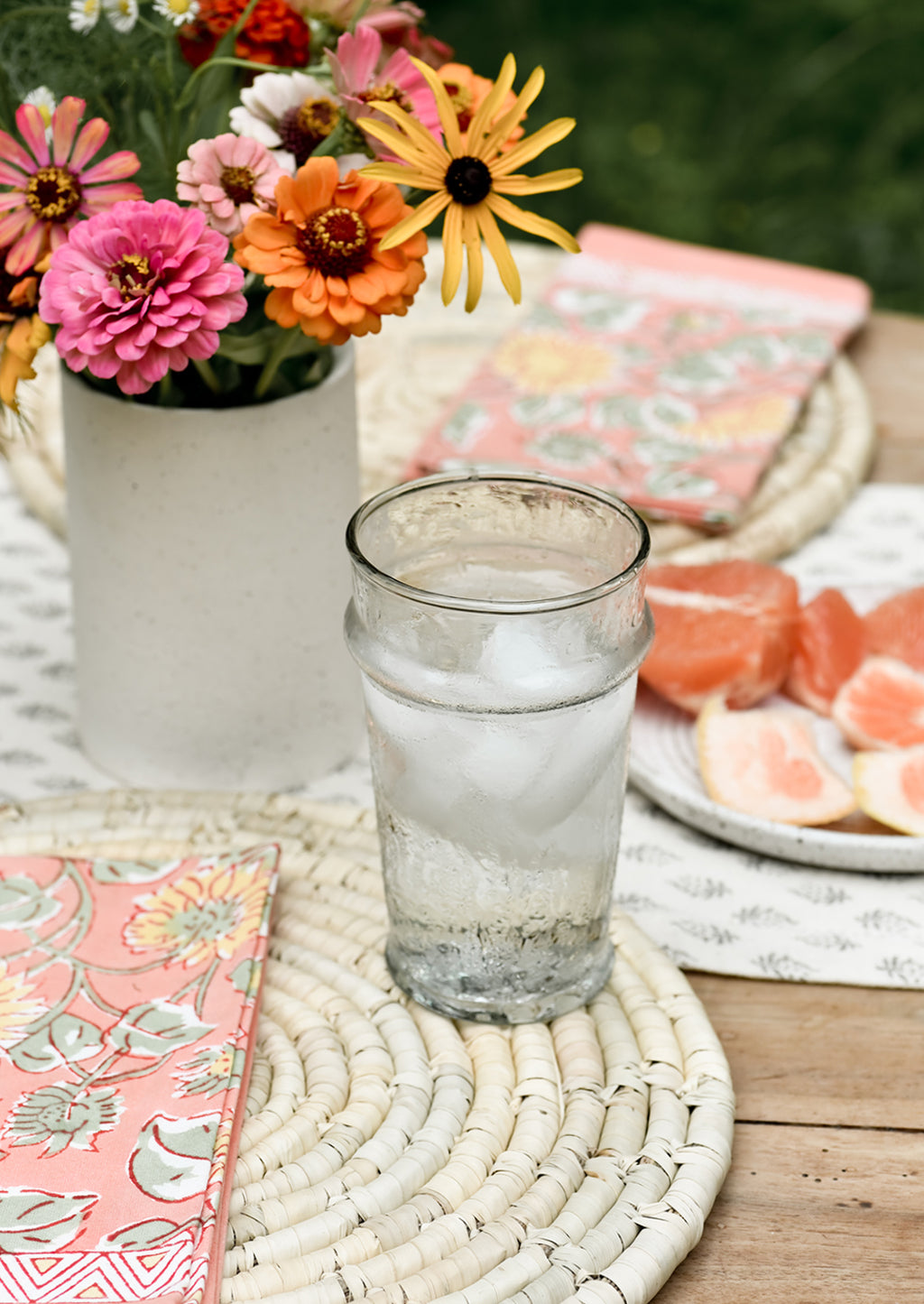 2: A table setting with placemats, napkins and water glass.