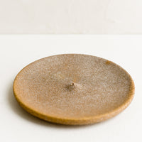 Sandy Brown: A round ceramic incense holder in matte sandy brown.