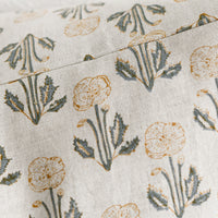 2: A natural linen throw pillow with floral block print pattern.