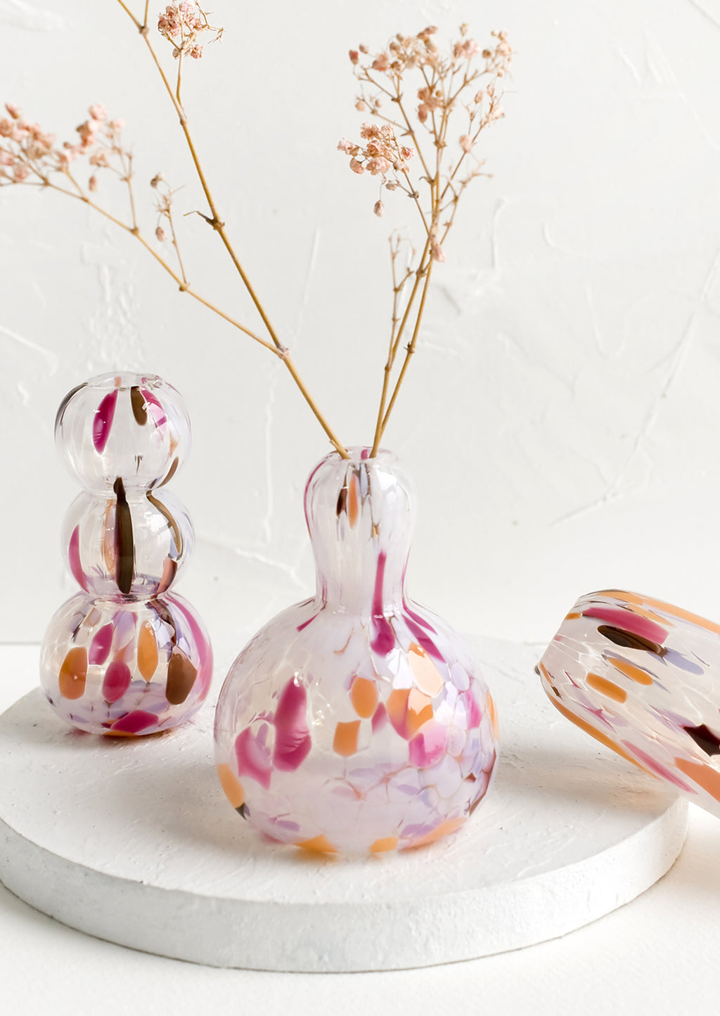 1: An assortment of glass vases in a range of shapes.
