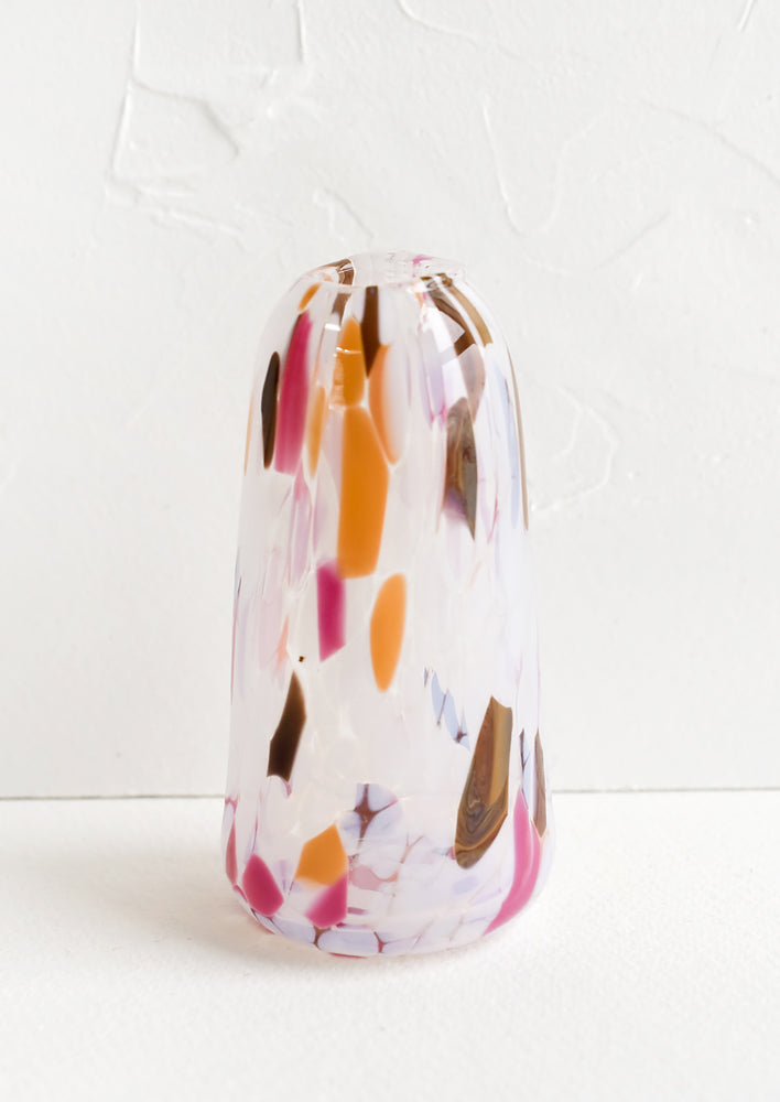 A tall tapered bud vase in glass with orange, brown and pink speckles.