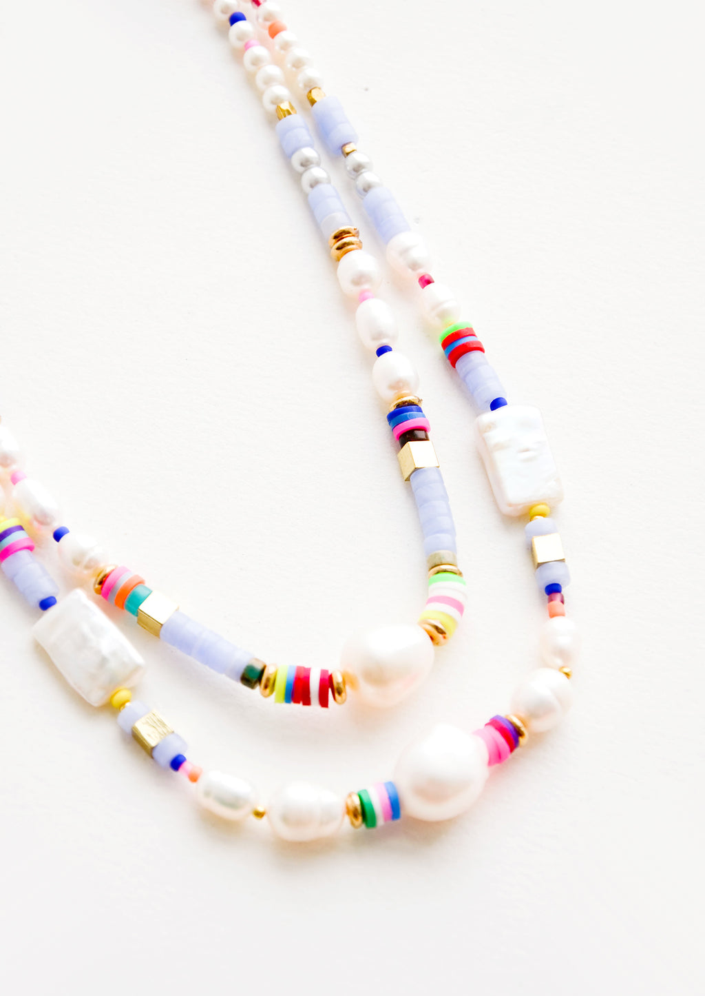 2: A mix of pearl, colorful plastic and gold metal beads on a double strand necklace