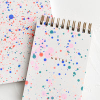 Notepad: Spiral bound notepad with neon paint splatter cover.