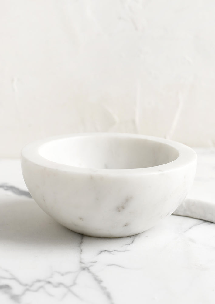 White: A small white marble bowl.