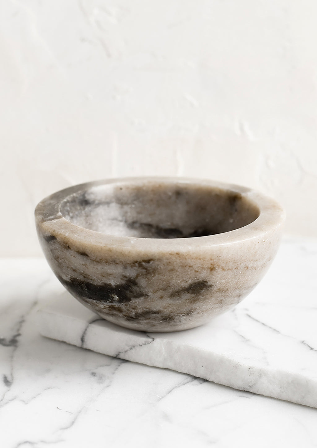 Tan: A small tan marble bowl.