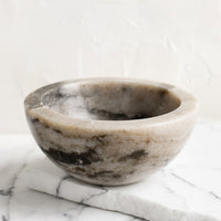 Tan: A small tan marble bowl.
