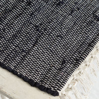 2: A black and white chindi weave table runner.