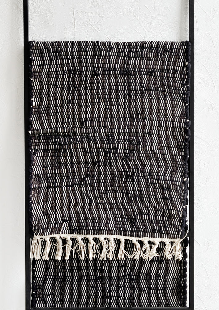 A black and white chindi weave table runner.