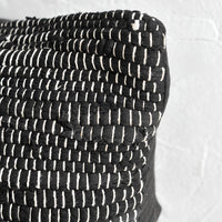2: A black and white chindi weave throw pillow.