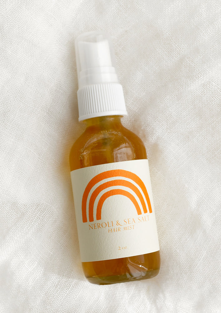Orange sea salt hair mist liquid in a clear spray bottle with label.