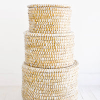 2: Stack of round, lidded storage baskets in three incremental sizes