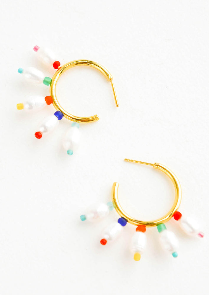 Gold, post-back hoop earrings adorned with freshwater pearls surrounded with colorful matte seed beads