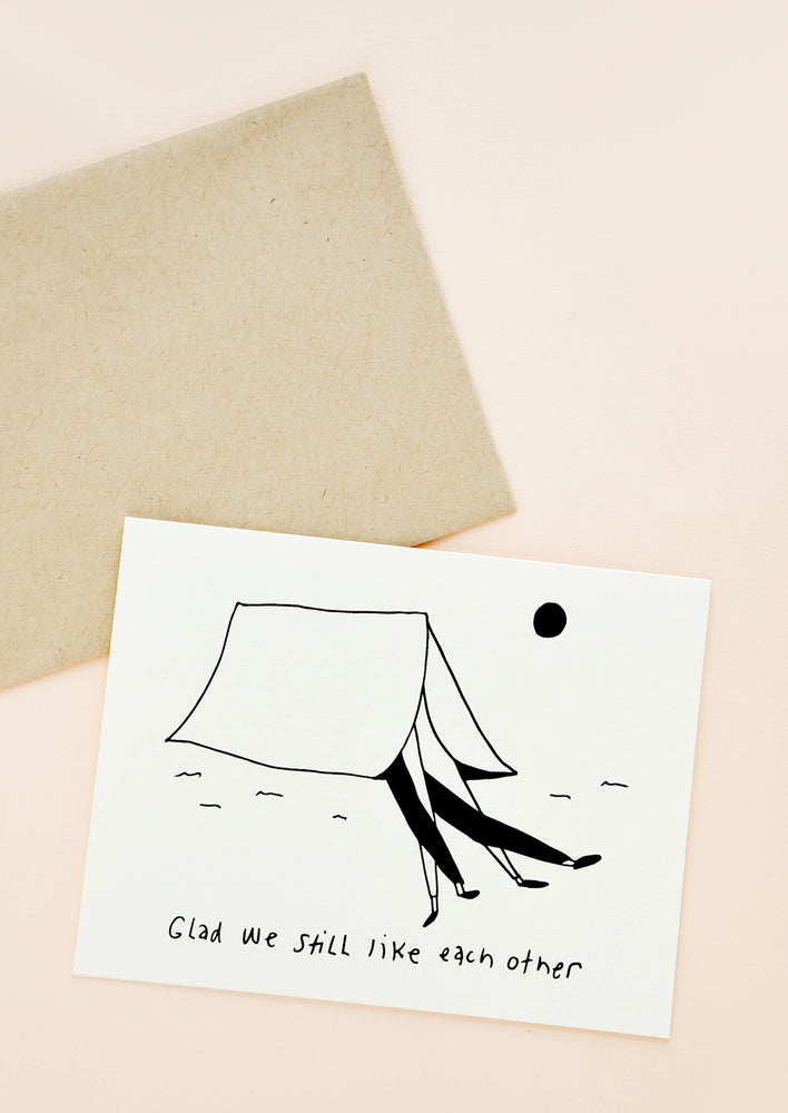 Greeting card picturing a couple's legs sticking out of a tent, with text underneath that reads "Glad we still like each other"
