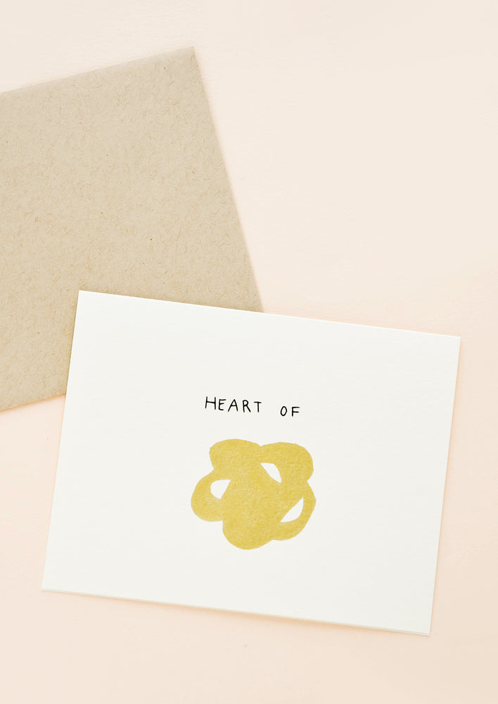 Greeting card with metallic gold scribble and "Heart of" written above it