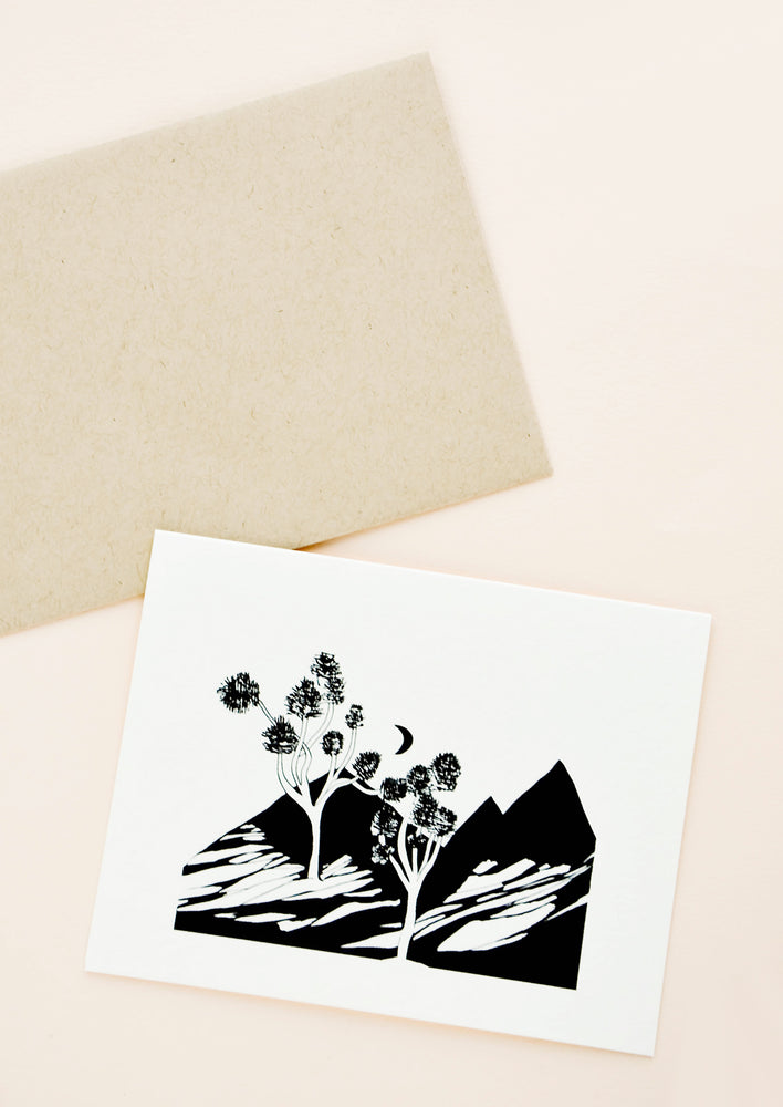Greeting card with black and white desert landscape scene printed on front