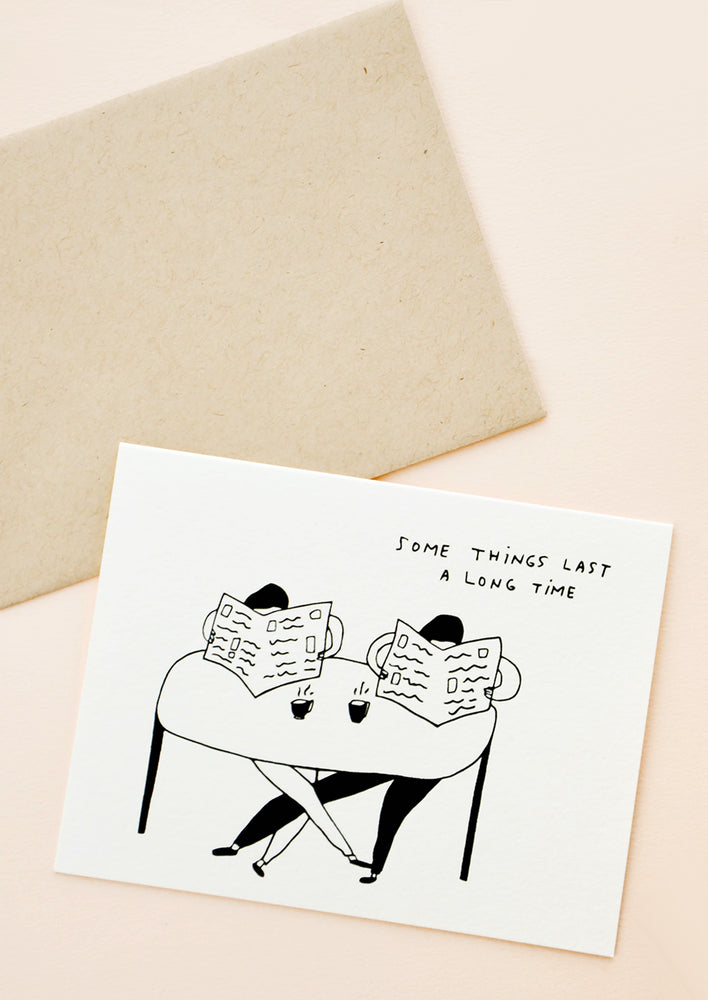 1: Greeting card with couple sitting at table with coffee cups and both reading newspapers, written text at corner reads "Some things last a long time"