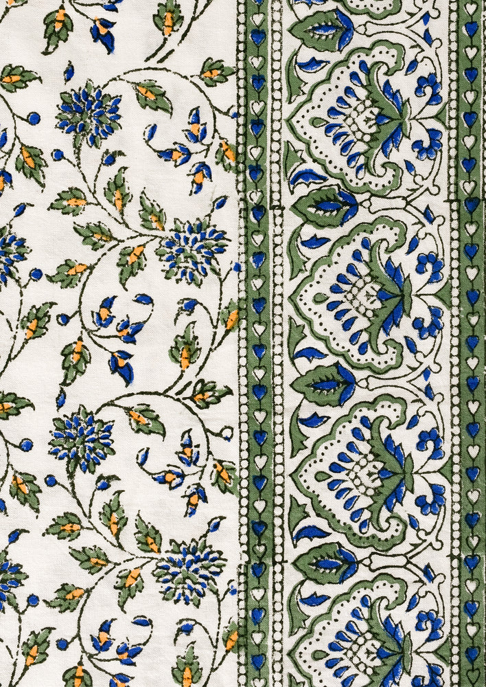 3: A block printed floral pattern with border in blue, green and orange.