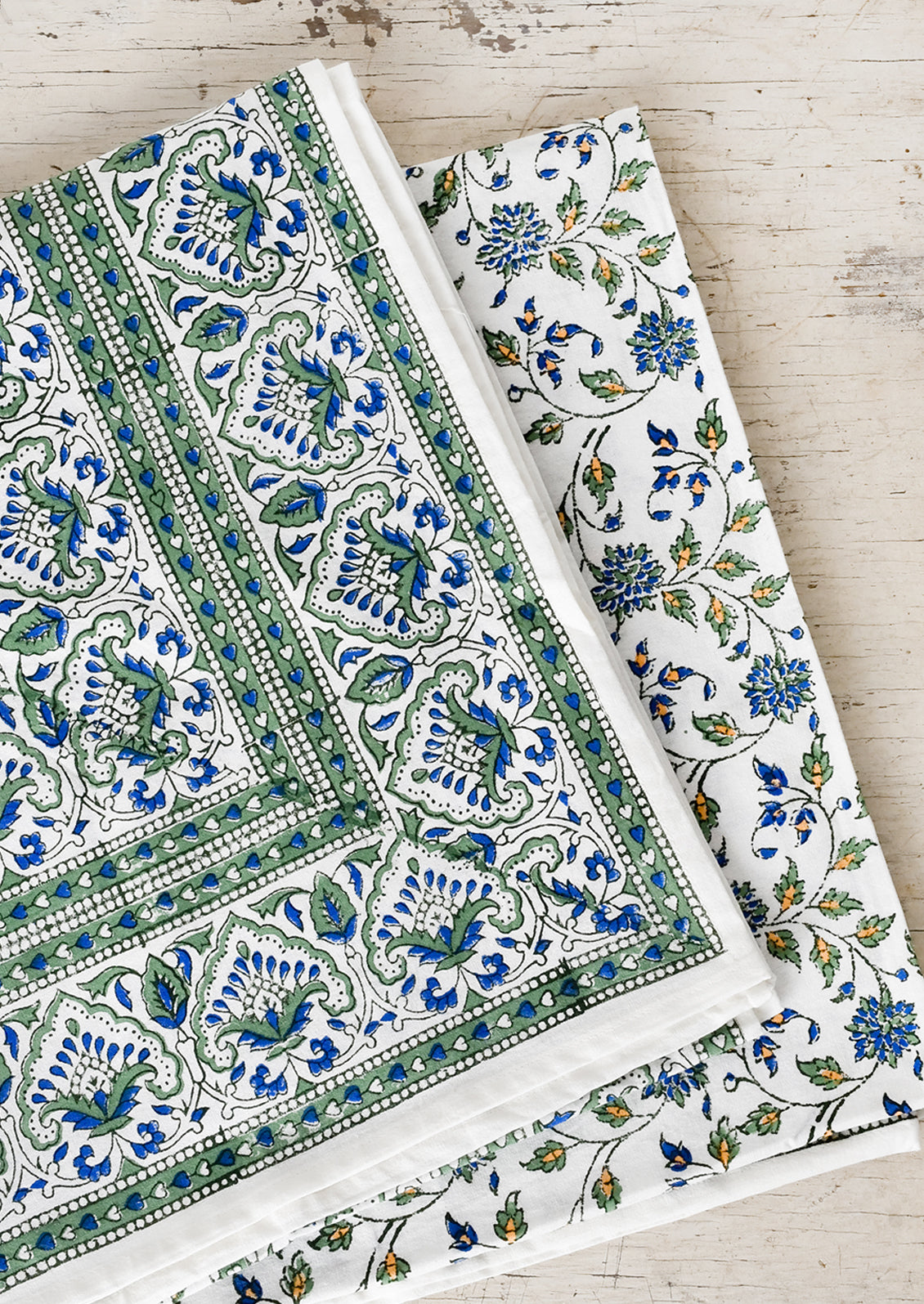 A block printed tablecloth in blue and green floral.
