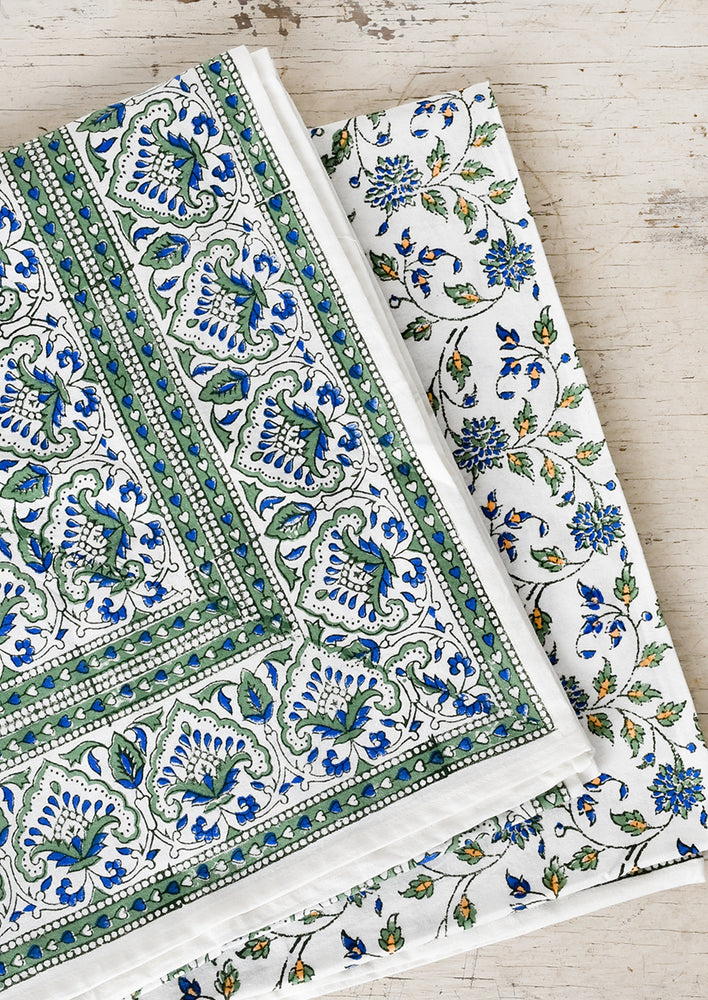 1: A block printed tablecloth in blue and green floral.