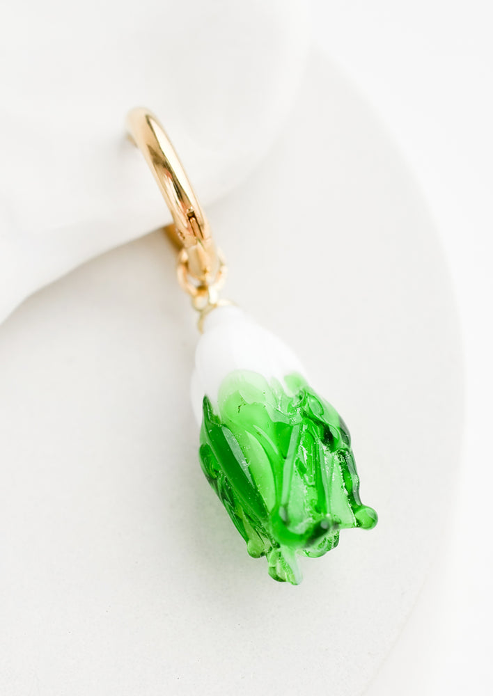 Cabbage: A single earring with glass cabbage charm on gold huggie hoop.