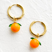 2: Gold huggie hoop earrings with glass tangerine charms.