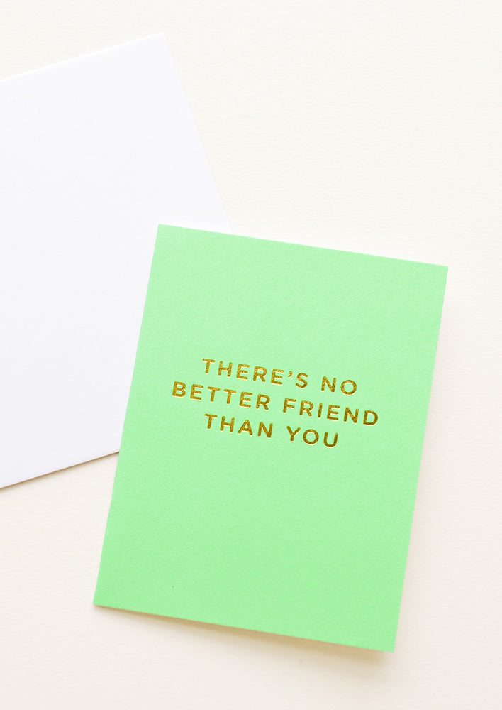 A neon green greeting card with gold foiled text reading "there's no better friend than you."