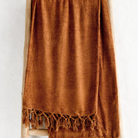 3: A chenille throw with knotted tassel trim in nutmeg copper color.