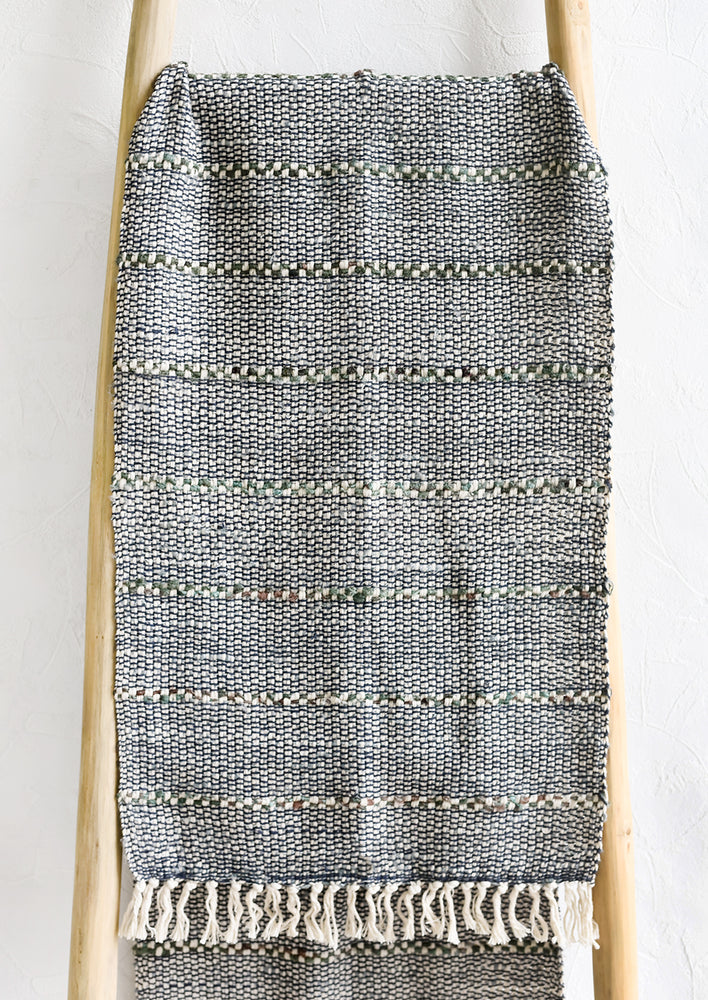 A blue and green table runner with stripe detail.