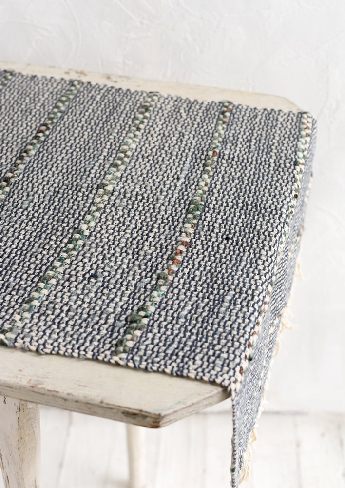 2: A blue and green table runner with stripe detail.