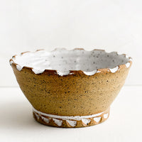 Natural / White Speckle: A ceramic bowl with carved notch rim in natural clay and white glaze.