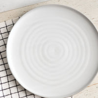 1: A round side plate with concentric circles pattern in soft grey glaze.