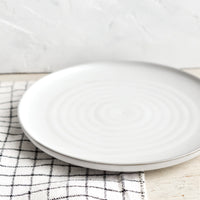 2: A round side plate with concentric circles pattern in soft grey glaze.
