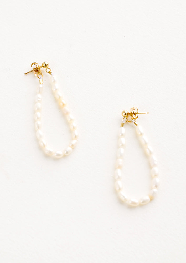 Pearl string earrings with two-sided post back closure that goes from the front to the back of the ear