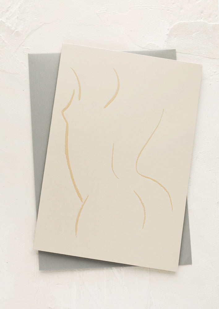 A greeting card with line drawing of nude silhouette.