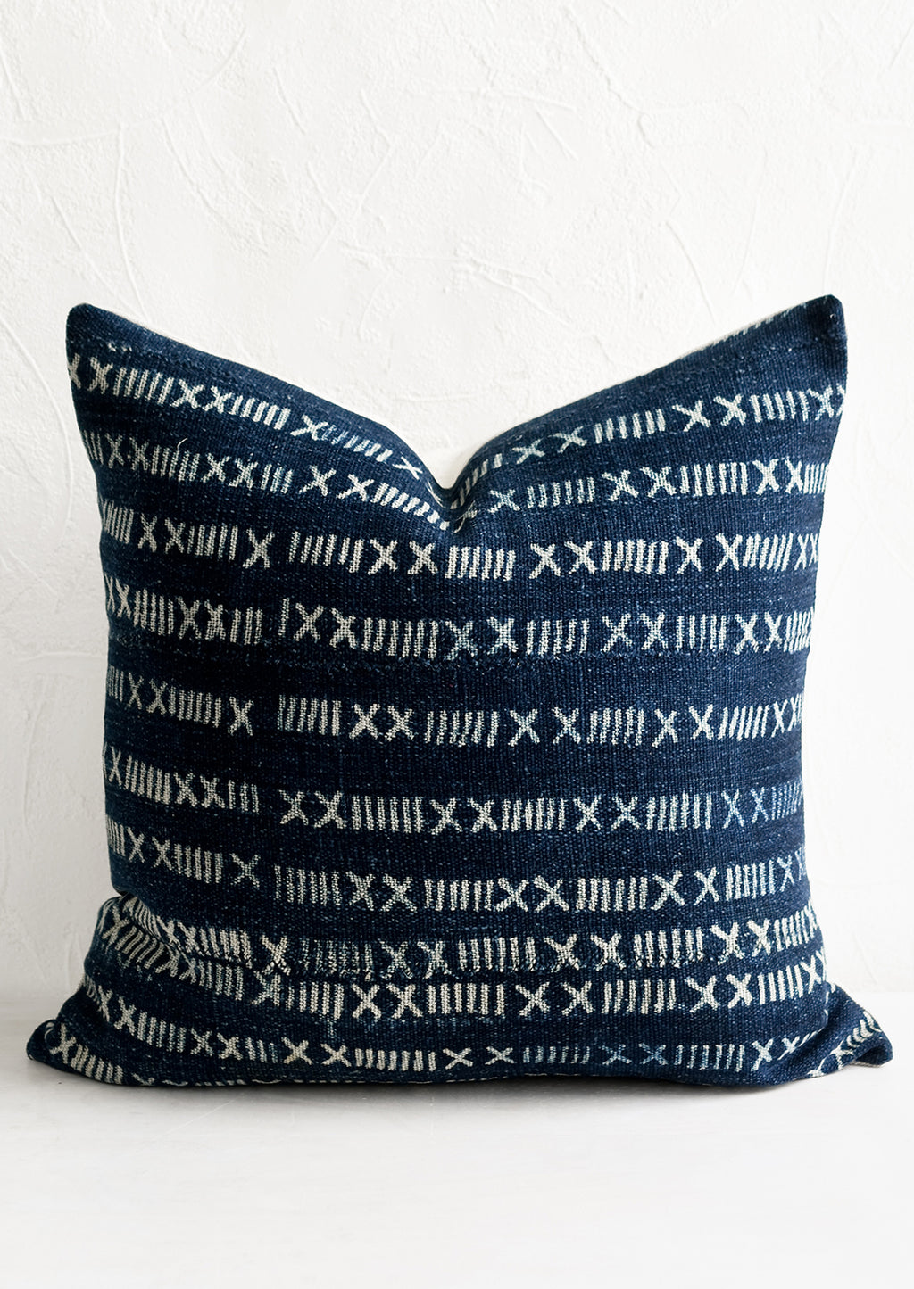 1: A throw pillow in indigo fabric with numeral pattern.
