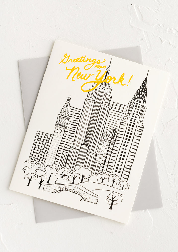 A greeting card with illustration of NYC skyline and text reading "Greetings from New York!".