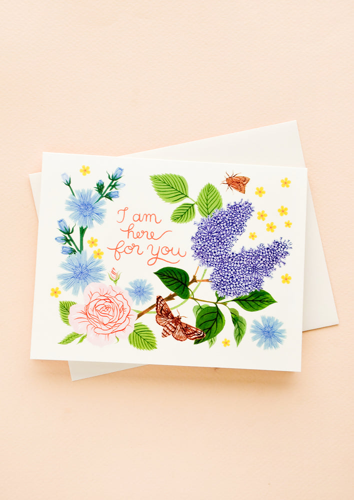 1: Greeting card with garden florals and bugs, red cursive text reads "I am here for you"