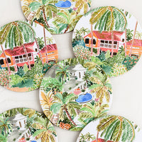 Oasis Getaway: A set of six printed round coasters in tropical oasis print.