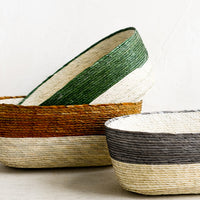2: Oval shaped straw storage baskets in assorted colors.