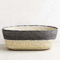 Mineral: A two-tone oval shaped storage basket in natural and mineral blue-grey.