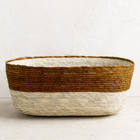 Ochre: A two-tone oval shaped storage basket in natural and ochre.