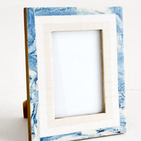 1: A decorative picture frame with a tiled border in marbled blue, white and cream.
