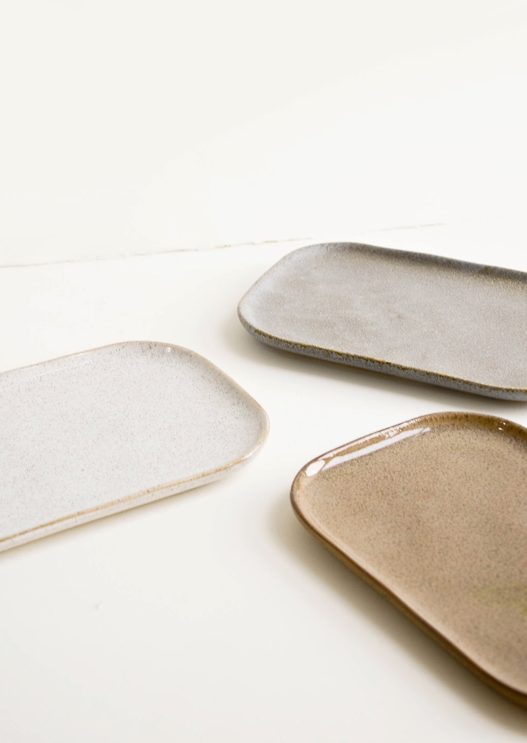 5: Trio of ceramic trays in earth tones.