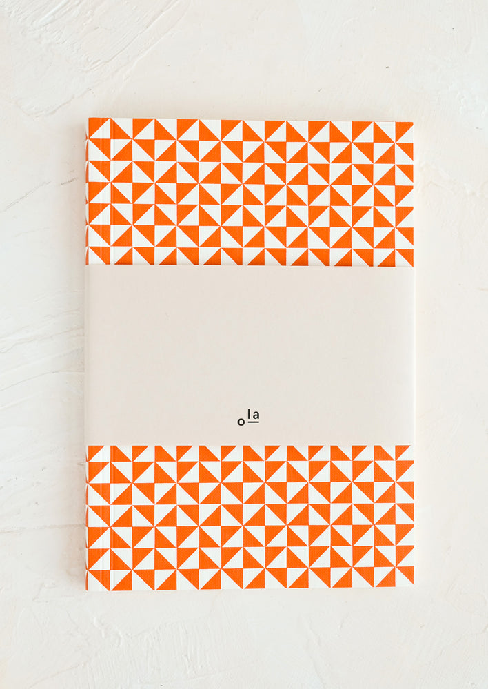 A large notebook with rust and white bunting print.