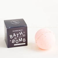Bergamot & Grapefruit: Pink colored, round bath bomb with black box packaging